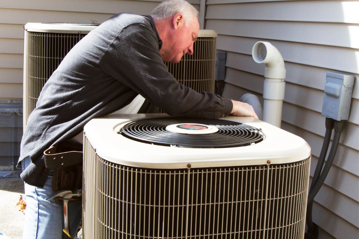man fixing lennox air conditioner