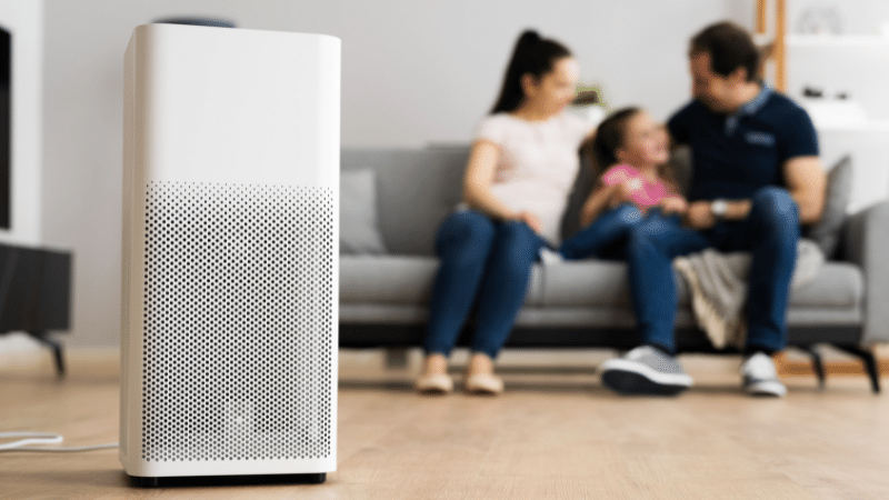 family in large room with air purifier
